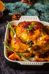 Christmas roasted chicken with cranberries, orange, spices and herbs. Christmas food concept.