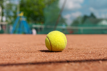 yellow tennis ball on a clay court, tennis infrastructure background