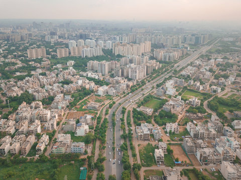 Aerial view of cars passing through a 2 way in urbanized gurgaon sector 34, delhi ncr, India.