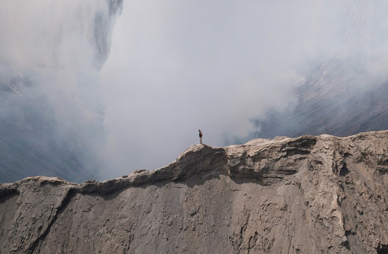 Aerial view of a man standing of the edge of mount Bromo in east of Java island of Indonesia.
