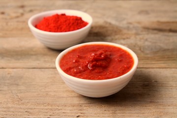 Traditional Maghrebi food: hot chili pepper sauce paste harissa and powder. Tunisia and Arabic cuisine adjika.