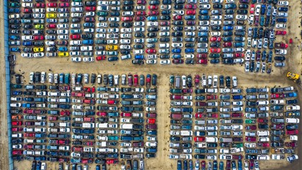 Aerial view of rows of old cars that have served, assembled in a junk yard waiting to be recycled for their reusable parts, Aurora, IL, USA.