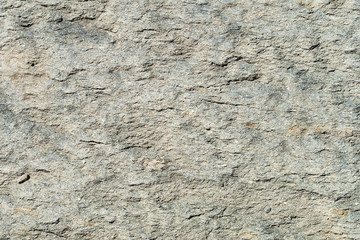Texture of natural stone gray. Background stone with a shallow relief.