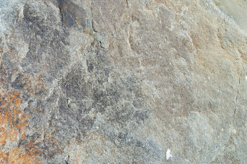 Texture of natural stone gray. Background stone in nature granite gray with rusty stains.