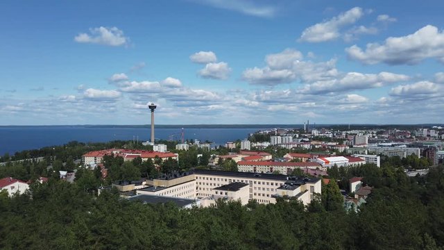 Tampere, Finland. View from Pyynikki observation tower. View to Näsinneula tower and lake Näsijärvi, city and lake Pyhäjärvi. Beautiful summer day. Aerial panning shot.