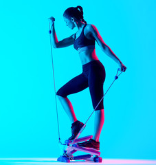 one mixed races woman exercsing Stepper fitness exercices isolated on blue blackground