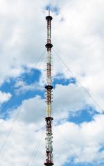 Obraz premium High TV tower on a cloudy sky background.