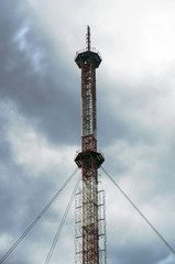 Obraz premium High TV tower on a cloudy sky background.