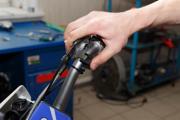 Hand pressing the Off-Run button on motorcycle