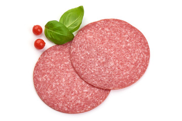 Salami sausage slices with basil leaves, top view, isolated on white background