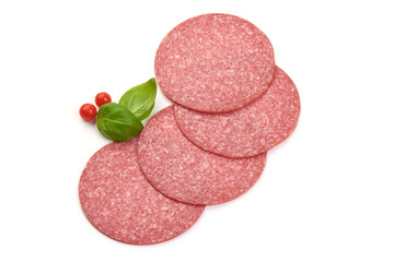 Thin salami sausage slices with basil leaves, top view, isolated on white background