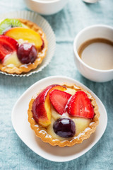 Mini tarts with cream and mix of summer fruit