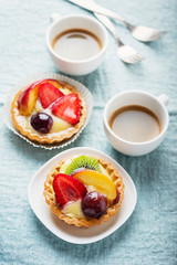 Obraz na płótnie Canvas Mini tarts with cream and mix of summer fruit