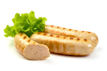 Grilled Bavarian sausages with lettuce, isolated on white background