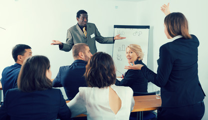 African American business coach communicating with auditorium
