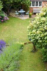A well kept back yard or garden with lawn and seating area, high angle shot
