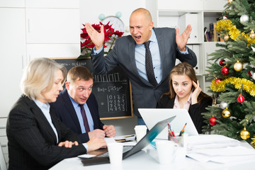 Unhappy businessman scolding his subordinates