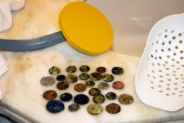 The photo of gold and silver  coins collected with help of underwater metal detector. Treasure searching and tourist adventure background.