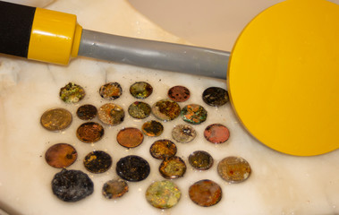 The photo of gold and silver  coins collected with help of underwater metal detector. Treasure searching and tourist adventure background.