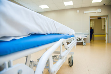 An interior of a hospital hallway with a stretchers