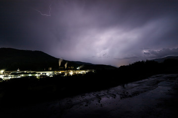 a dangerous storm in a summer night full of lighting bolts with view above the austrian city of leoben to the east