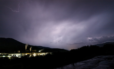 a dangerous storm in a summer night full of lighting bolts with view above the austrian city of leoben to the east