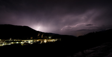 a dangerous storm in a summer night full of lighting bolts with view above the austrian city of leoben to the east