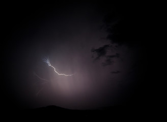 a dangerous storm in a summer night full of lighting bolts with view above the austrian city of leoben to the east