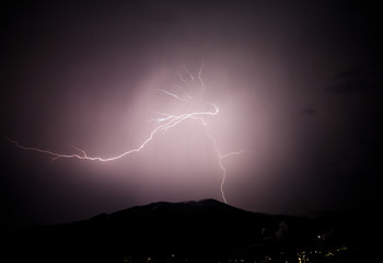 Naklejka na ściany i meble a dangerous storm in a summer night full of lighting bolts with view above the austrian city of leoben to the east
