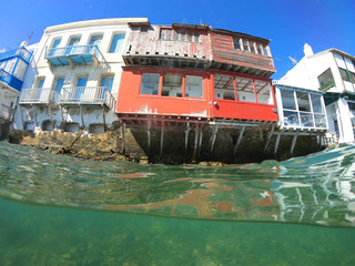 Split of above and underwater photo of iconic and beautiful colourful - whitewashed Little Venice...