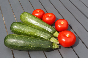 Summer vegetables, whole tomatoes and zucchinis