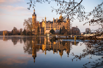 Dawn at Schwerin Palace (Schweriner Schloss), reflected in the water of Schweriner See lake. World Heritage Site in Mecklenburg-Vorpommern, Germany