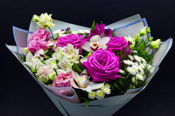 bright contrasting bouquet of fresh flowers on a dark background