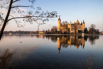Dawn at Schwerin Palace (Schweriner Schloss), reflected in the water of Schweriner See lake. World Heritage Site in Mecklenburg-Vorpommern, Germany