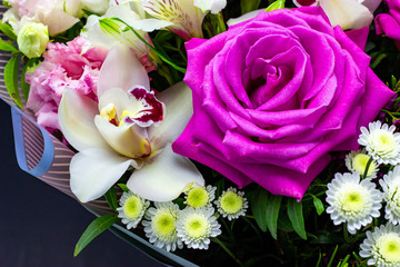 bright contrasting bouquet of fresh flowers on a dark background