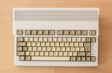 Vintage old computer from the 90's on wooden background