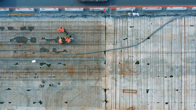 Aerial top view of reconstruction of overpass road in the city. Top view of roadworks by road workers