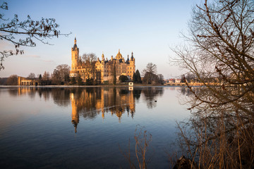Dawn at Schwerin Palace (Schweriner Schloss), reflected in the water of Schweriner See lake. World Heritage Site in Mecklenburg-Vorpommern, Germany