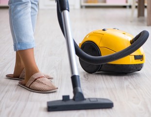 Woman doing cleaning at home with vacuum cleaner