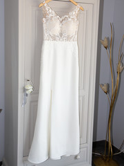 White modern wedding dress on a hanger