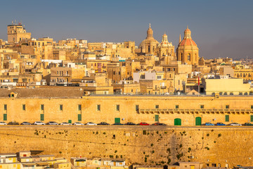 Fototapeta premium Valletta from the Ship. Exposure of Valletta, Malta, taken at Sunrise from a ship while arriving at this beautiful fortified city.