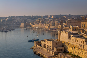 Fototapeta premium Valletta from the Ship. Exposure of Valletta, Malta, taken at Sunrise from a ship while arriving at this beautiful fortified city.