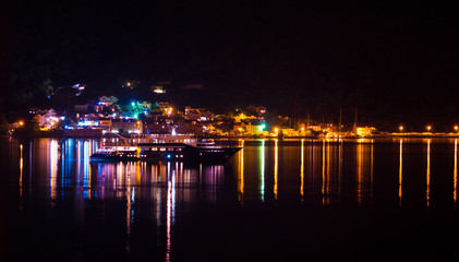 Fototapeta na wymiar Beautiful night sightseeing over the light reflections on Kotor bay
