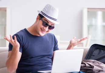 Man booking online his travel flight and hotel