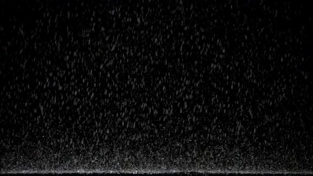 highspeed plate shot isolated rain pouring onto floor against black background