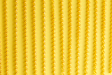 Raw fusilli lunghi pasta over yellow background.jpg