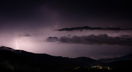a dangerous storm in a summer night full of lighting bolts with view above the austrian city of leoben to the east