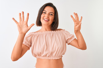 Young beautiful woman wearing casual t-shirt standing over isolated white background showing and...