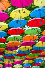 Fototapeta na wymiar Colorful umbrellas background. Colorful umbrellas in the sky as decoration