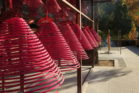 Rows of red incense coils at Taoist shrine